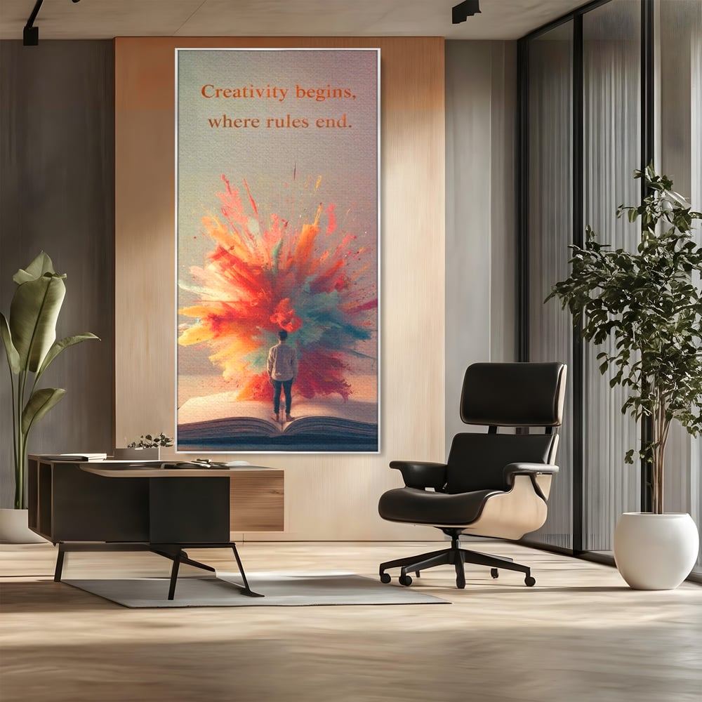 Tablou canvas cu tablou canvas cu barbat privind o explozie de culoare dintr-o carte deschisa, in rama de aluminiu argintiu, pe perete intr-un birou