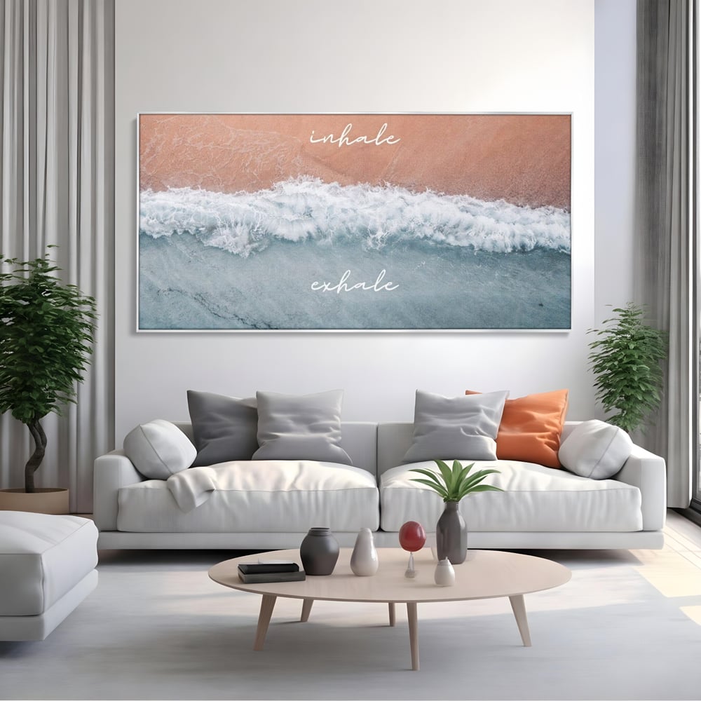 Tablou canvas cu tablou canvas cu plaja si valuri, in rama de aluminiu argintiu, pe perete intr-un living
