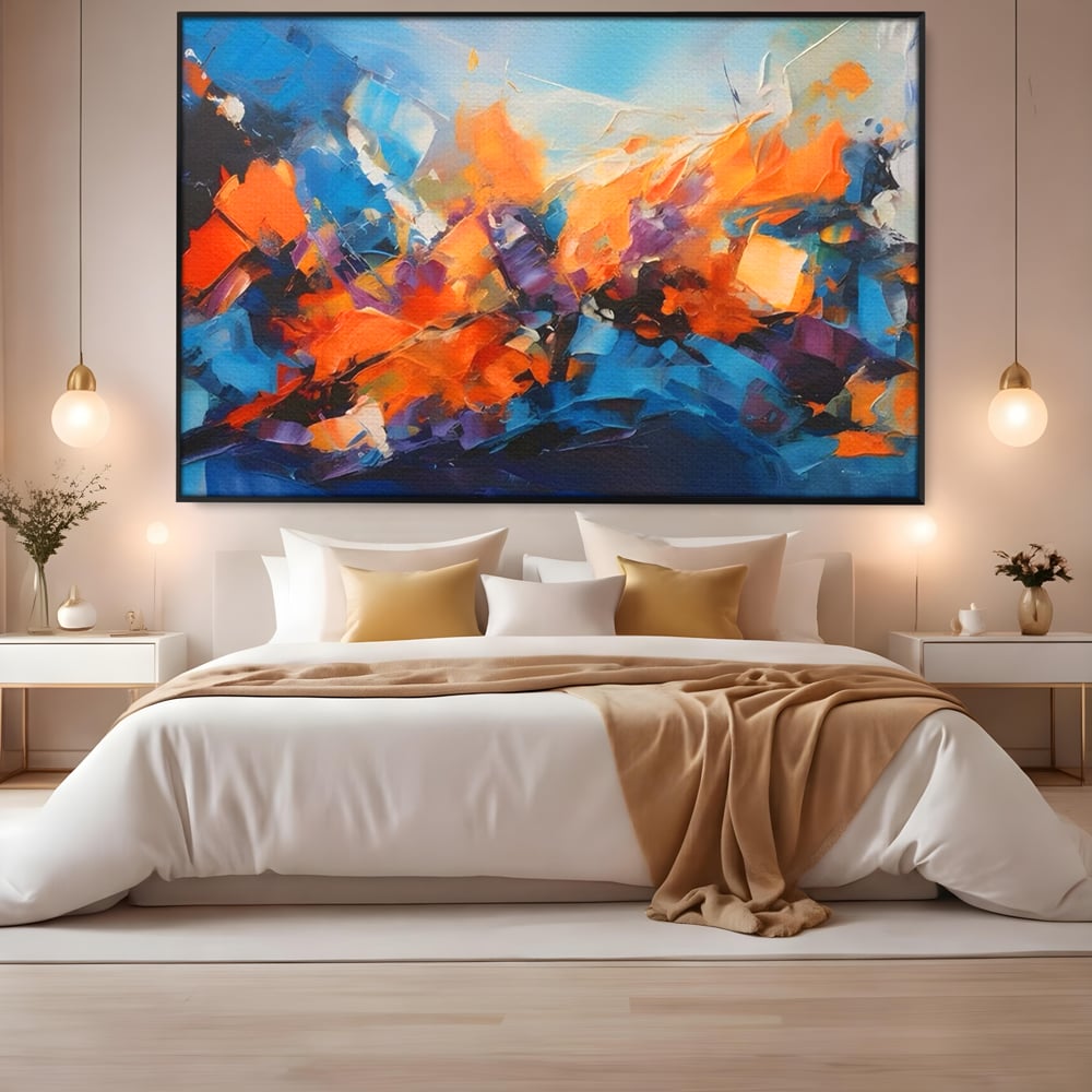 Tablou canvas cu pictura abstracta cu pete portocalii, in rama de aluminiu negru, pe perete intr-un dormitor